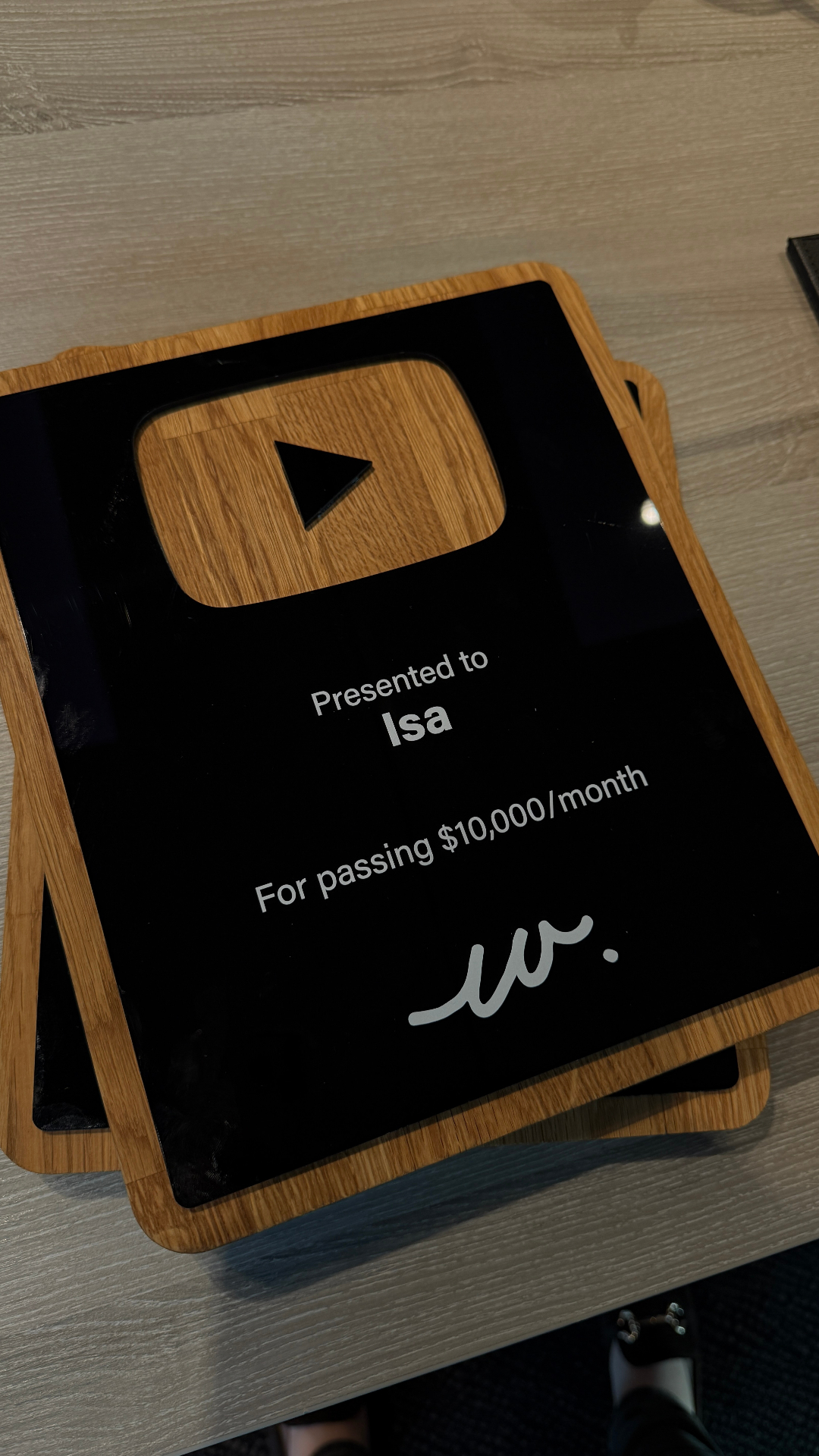 Isa receiving a 10K per month award at the live event